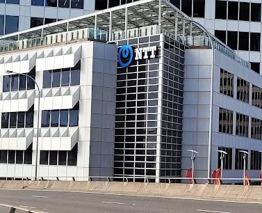 NTT Company Logo (Says NTT and has a blue ribbon above)